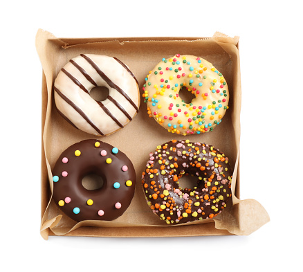 Tasty glazed donuts in cardboard box isolated on white, top view