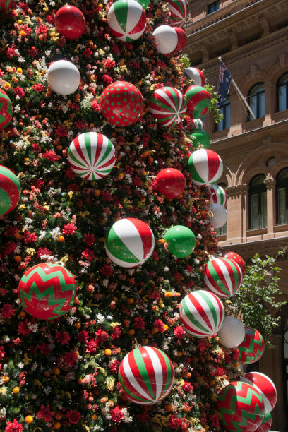 istock Close up of Christmas tree decorations with sandstone building in background 1335868192