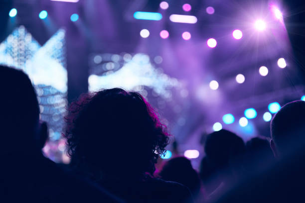 istock De-focused concert stage with laser lights and beams. 1335868323