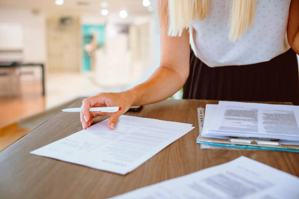 Preparing for the school exam Female teacher grading school tests on the desk. Woman grading paper homework. Copy space business teaching student writing stock pictures, royalty-free photos & images