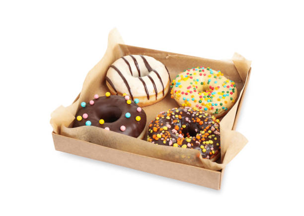 istock Tasty glazed donuts in cardboard box isolated on white 1335869603