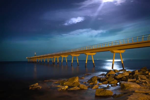 istock bridge and sea with stones at night 1335869617