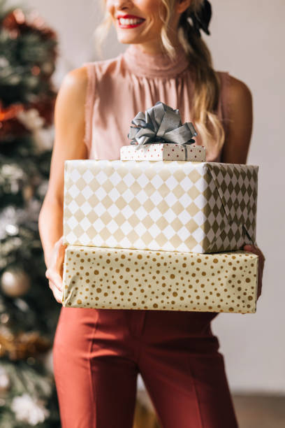 istock An Anonymous Woman Holding a Christmas Presents in her Hands 1335871265