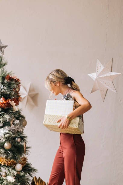 istock An Anonymous Woman Holding a Christmas Presents in her Hands 1335871268