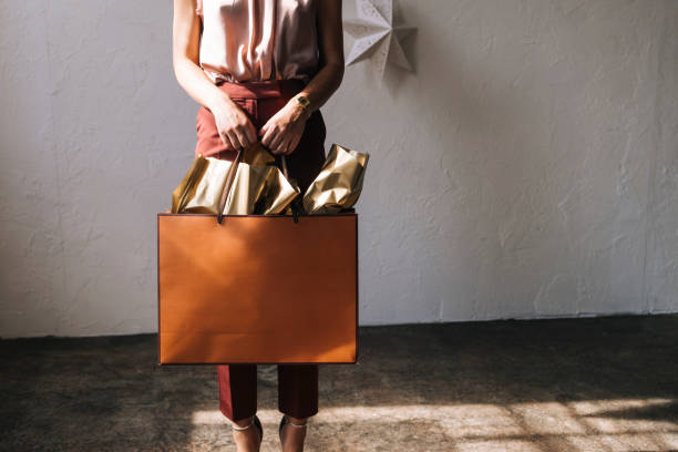 istock An Anonymous Woman Holding Christmas Present at Home 1335871277