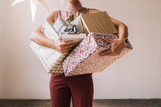 istock Unrecognizable Woman Holding Christmas Presents in her Hands 1335871292