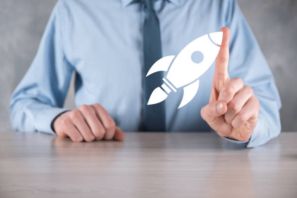 istock Start up concept with businessman holding abstract digital rocket icon rocket is launching and soar flying 1335872073