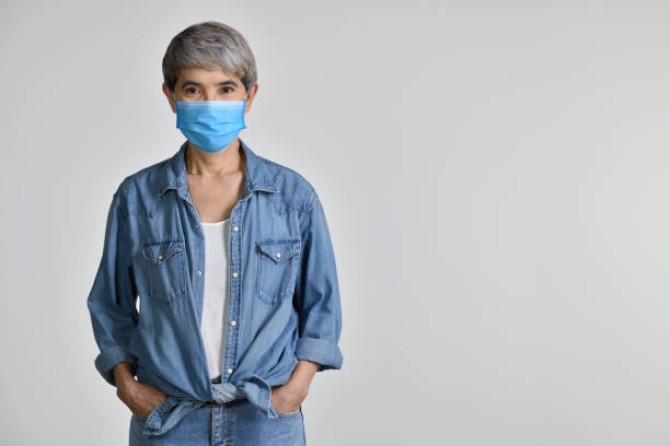 istock Asian woman wearing surgical mask 1335874062