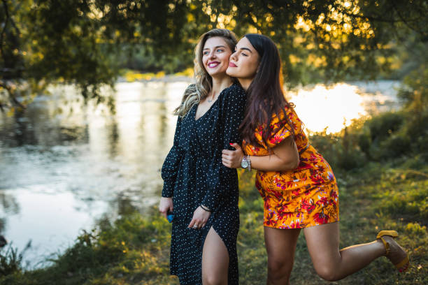 istock Loving lesbian couple enjoy sunset by the river 1335874938