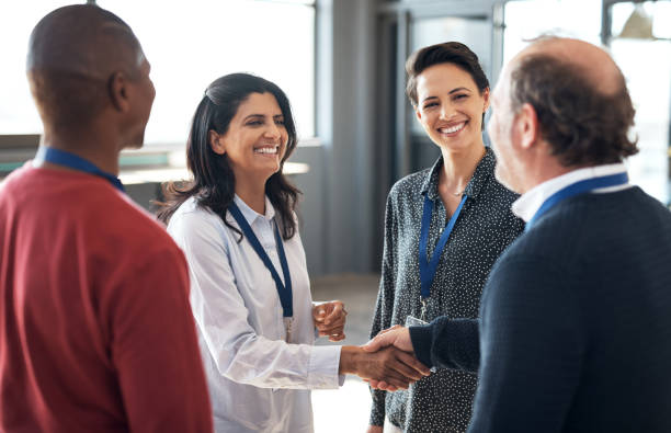 Shot of a group of businesspeople networking at a conference Establishing relationships with key people across various industries Tradeshow stock pictures, royalty-free photos & images