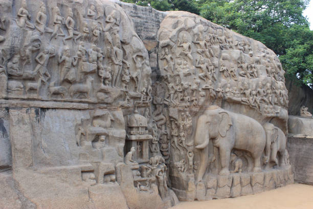 Descent of the Ganges. A giant open-air rock bas relief carved on two monolithic rocks in Mahabalipuram. Tamilnadu, India.  Carved Sculpture of animals, God, people and half-humans Descent of the Ganges. A giant open-air rock bas relief carved on two monolithic rocks in Mahabalipuram. Tamilnadu, India.  Carved Sculpture of animals, God, people and half-humans dravidian culture stock pictures, royalty-free photos & images