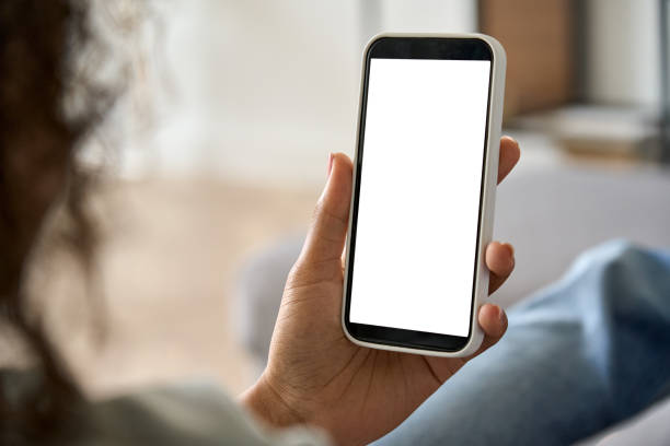 istock African American woman using smartphone with mockup white blank display. 1335876731