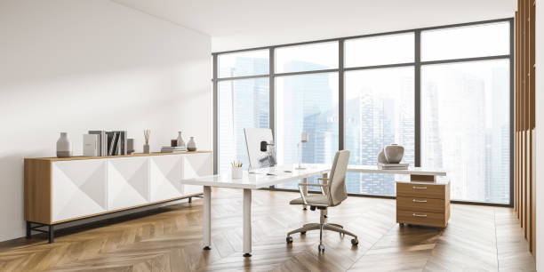 istock View on corner of panoramic beige office with sideboard, desk 1335878920