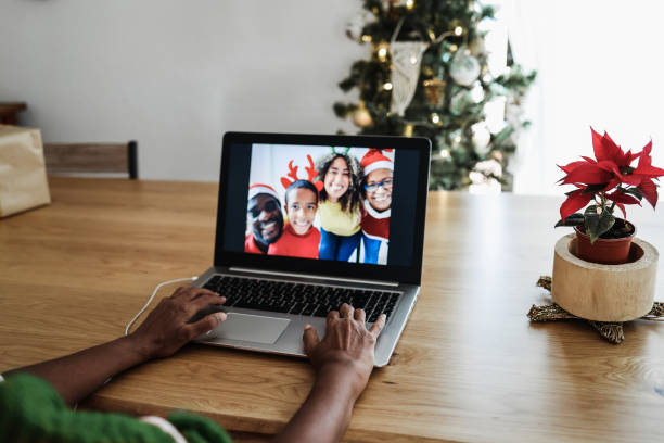 istock Multiracial family doing video call during Christmas time - Focus on right hand 1335879163