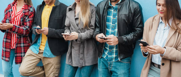 istock Young people using mobile phones outdoor - Focus on hands 1335882057
