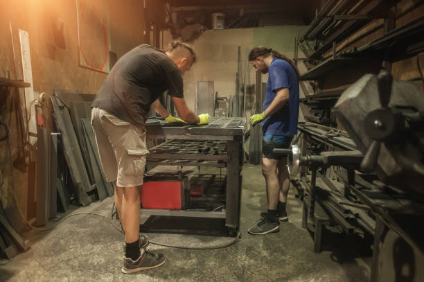 istock Two craftsman working on steel structure in factory 1335882281