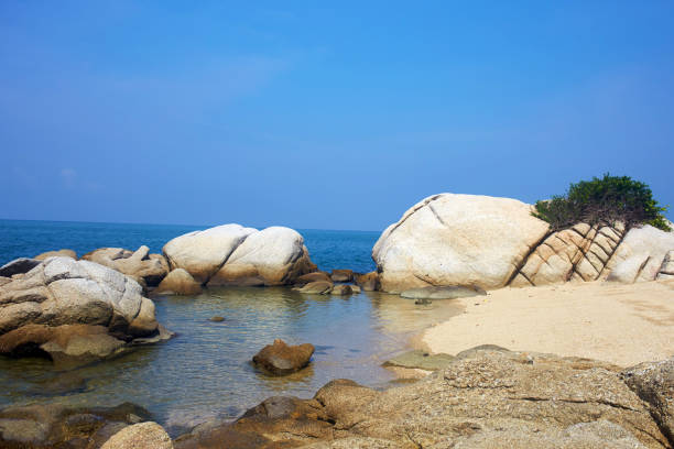 istock Beautiful summer seascape. Huge stones on a sandy beach. 1335883835
