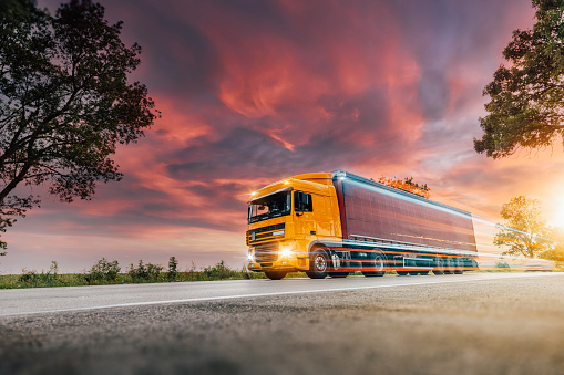 Orange Lorry on a motorway in motion near London, United Kingdom