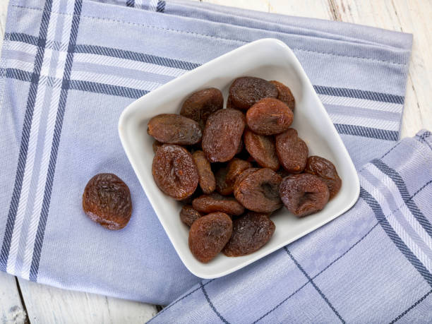istock Dried apricots without sulfur in bowl on table, high angle view 1335887488