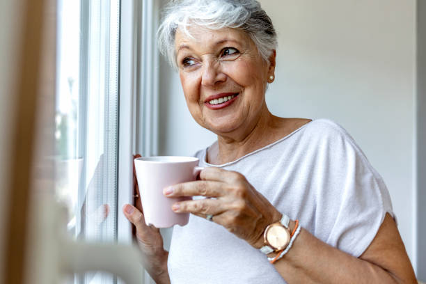 istock Beautiful old lady behind the window. 1335890170