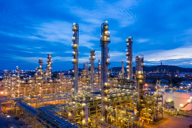twilight landscape oil and gas lpg refinery factory with storage zone industry business import and export at night over lighting blue sky background aerial view from drone - plant oil imagens e fotografias de stock