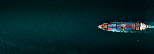 istock Container ship for import and export, business logistic and transportation by container ship in open sea, Aerial top view container cargo ship with copy space for design banner web background 1335890727