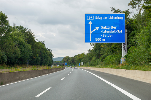 Salzgitter, Germany - August 16, 2021: Traffic on german Autobahn A39 nearby Salzgitter in Lower Saxony. The Bundesautobahn 39 (abbreviated as BAB 39 or A 39) is a German highway that connects the cities of Salzgitter, Braunschweig and Wolfsburg. Some road users in the background.