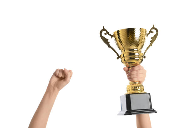 istock Woman holding gold trophy cup on white background, closeup 1335894363