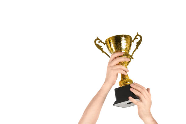 istock Man holding gold trophy cup on white background, closeup 1335895577