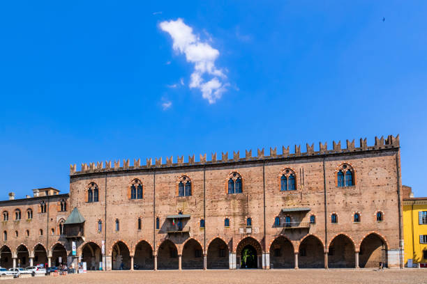 The Ducal Palace of Mantua is a group of buildings built between the 14th and the 17th century, located in the core of the historic city centre. People strolling in the square.