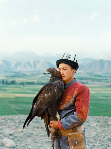 istock Eagle hunter standing on the background of mountains  in Kyrgyzstan 1335896721