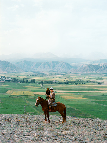 Eagle hunter on horse in steppe  in Kyrgyzstan
