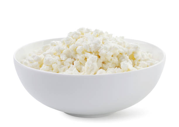 istock Cottage cheese in a plate on a white background. Isolated 1335898050