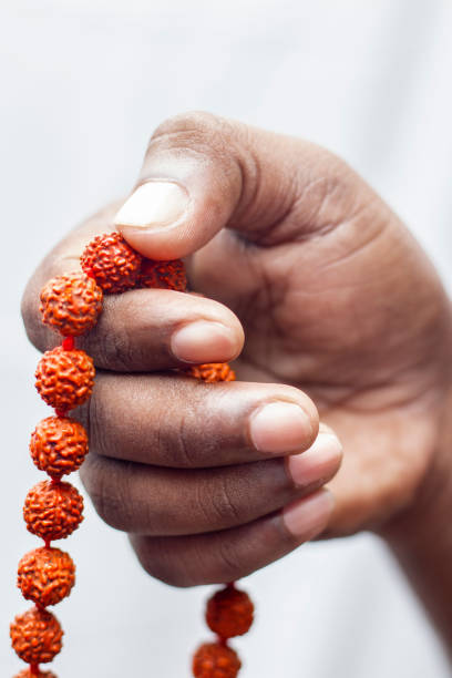 istock selective focus of a chanting hand with rudraksha beads. 1335898571