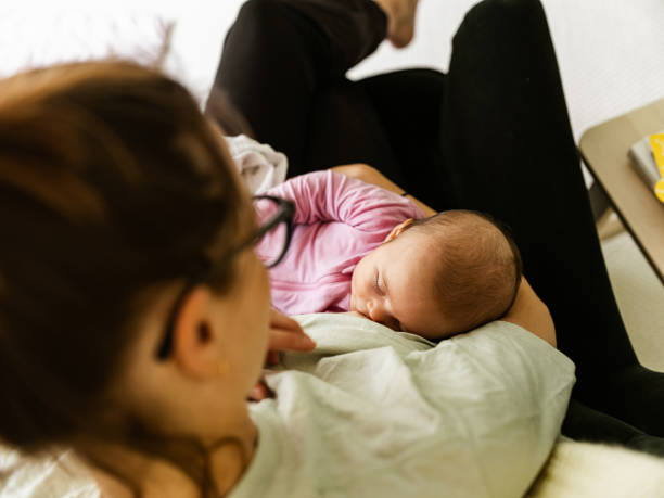 istock Young mother breastfeeding baby at home 1335898749