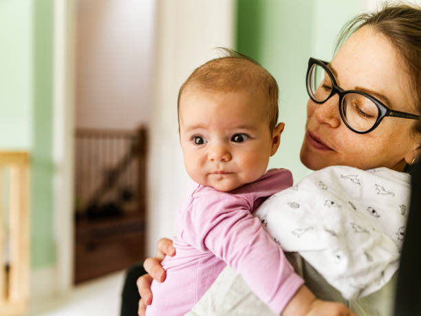 istock Young mother with baby at home 1335898768