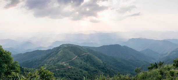 istock Crepuscular rays through clouds and mountains at sunset 1335900235