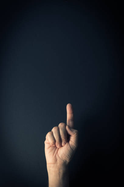 istock Colour image of hand demonstrating sign language number one with background and empty copy space 1335900301