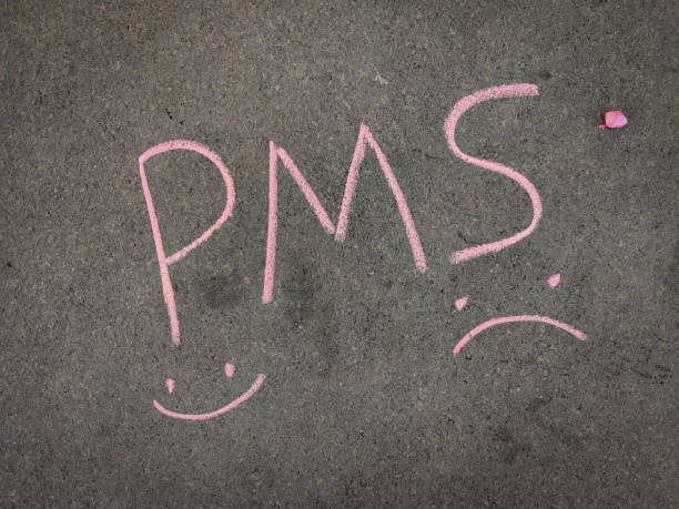 istock The inscription text on the grey board, PMS (Premenstrual syndrome) with hand drawn happy&sad emojis. Using color chalk pieces. 1335900885