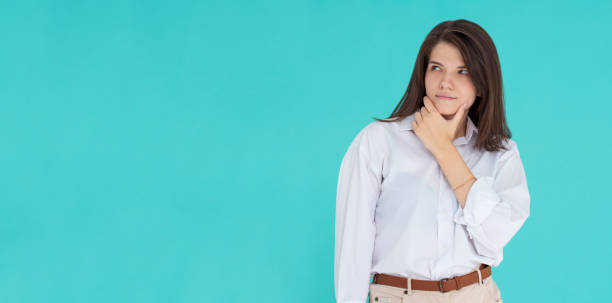 istock Thoughtful girl in studio. isolated blue backgroind 1335900951