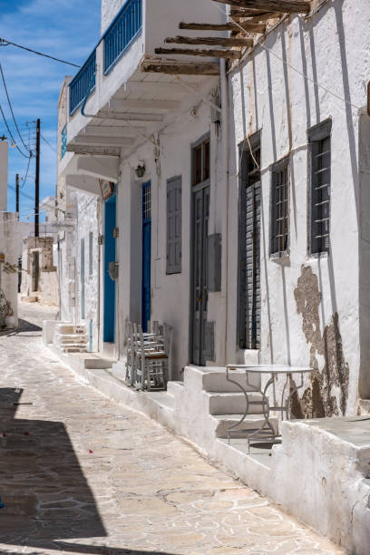 istock Whitewashed closed shops cobblestone alley Kimolos island Cyclades Greece. Vertical 1335901839