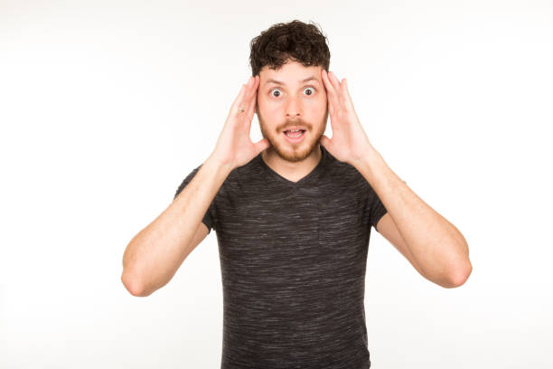 istock young caucasian man with dark hair with beard and surprised expression looking at camera 1335902869