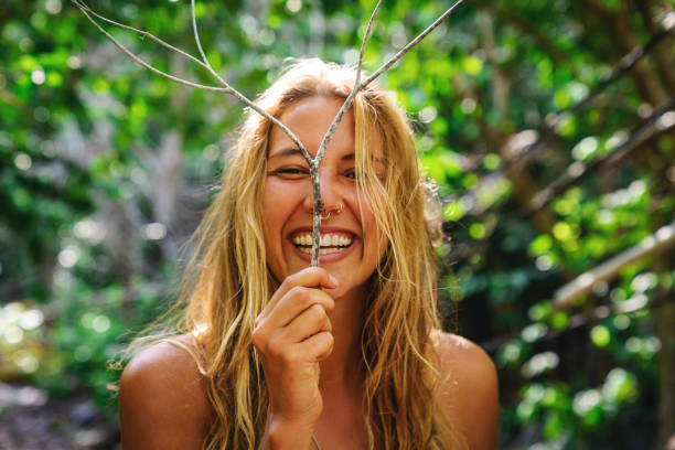 young beautiful woman holding a branch and makes herself a deer - leaf epidermis imagens e fotografias de stock