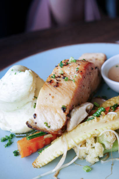 istock tasty salmon, mash potato and vegetable on plate 1335904236