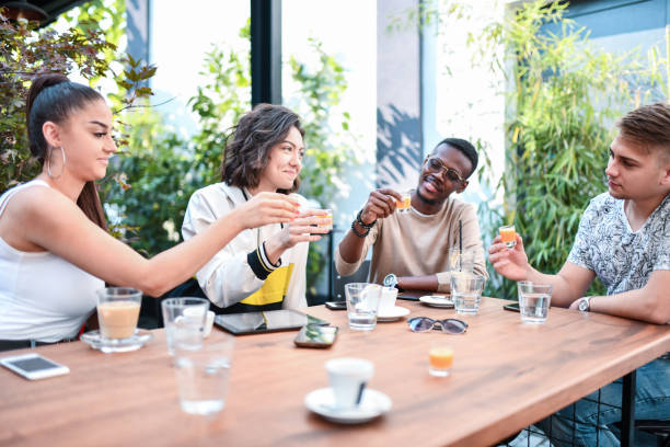 istock Celebratory Toast With Juice For Smiling Student Friends 1335904279