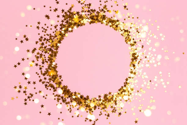 istock Round frame made of gold colored confetti. 1335905077