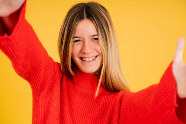 istock Young woman looking at camera and taking a selfie. 1335905152