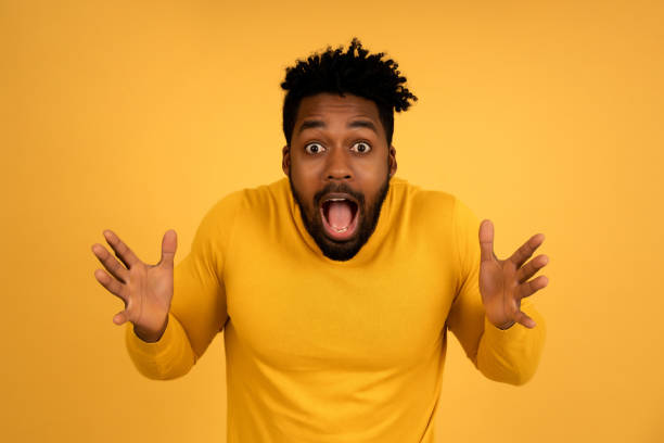istock Portrait of a young afro man with shocked expression. 1335905516
