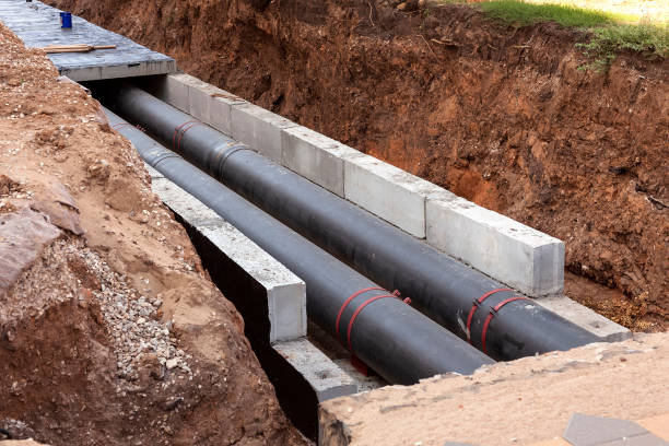 Insulated pipes in the trench. Water main reconstruction and replacement. Insulated pipes in the trench. Water main reconstruction and replacement. underground pipeline stock pictures, royalty-free photos & images