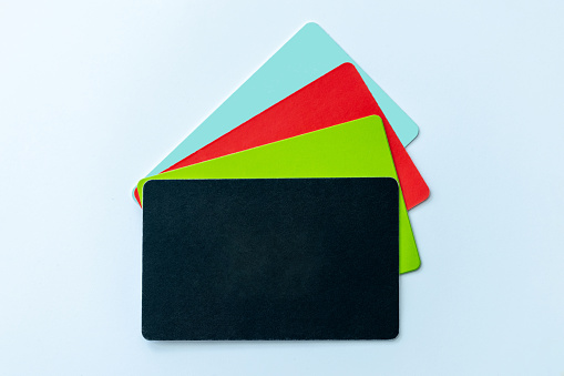 Rainbow Folders of School or Office Supplies on a Blue Background